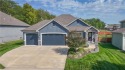 Welcome to comfort and style in this charming 1.5-story reverse for sale in Olathe Kansas Johnson County County on GolfHomes.com