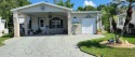 This meticulous three bedroom, 2 bath home has a brick exterior for sale in Lakeland Florida Polk County County on GolfHomes.com