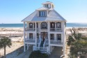 Nestled within a gated community, this stately GULF FRONT home for sale in Gulf Shores Alabama Baldwin County County on GolfHomes.com