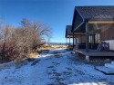 The deck of each Cottage overlooks the fishable Warm Springs for sale in Anaconda Montana Deer Lodge County County on GolfHomes.com