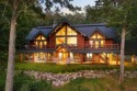 Welcome to this stunning Up North luxury log home perfectly for sale in Boyne Valley Twp Michigan Charlevoix County County on GolfHomes.com