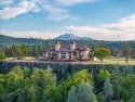 Passing through a custom lava rock gated entry to the impressive for sale in Fall River Mills California Shasta County County on GolfHomes.com