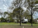 This lovely treed double-lot with the Fifth Wheel and shed are for sale in Quitman Texas Wood County County on GolfHomes.com
