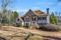 Behind the gates of Sugarloaf Country Club, this 7,000 plus sq for sale in Duluth Georgia Gwinnett County County on GolfHomes.com