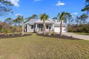 Experience the best of coastal living in this impeccable fully for sale in Carabelle Florida Franklin County County on GolfHomes.com