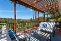 Passing through the hand-crafted wrought iron security gates and for sale in Woodland Hills California Los Angeles County County on GolfHomes.com