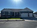 Come see this move-in ready rambler with a fully finished for sale in Hooper Utah Davis County County on GolfHomes.com