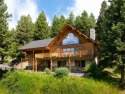 This charming log home, nestled in the trees and perched above for sale in Big Sky Montana Gallatin County County on GolfHomes.com