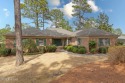 Nestled among the serene longleaf pines, this charming brick for sale in Southern Pines North Carolina Moore County County on GolfHomes.com