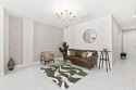 Discover refined lakefront living in this exquisite Toll for sale in Deerfield Beach Florida Broward County County on GolfHomes.com