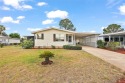 This 2 bedroom 2 bath home is situated on an oversized lot just for sale in Tavares Florida Lake County County on GolfHomes.com