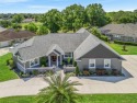 Discover refined Florida living in this beautifully crafted for sale in Lady Lake Florida Lake County County on GolfHomes.com