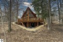 Superb log home character in a gated community on the signature for sale in Bellaire Michigan Antrim County County on GolfHomes.com